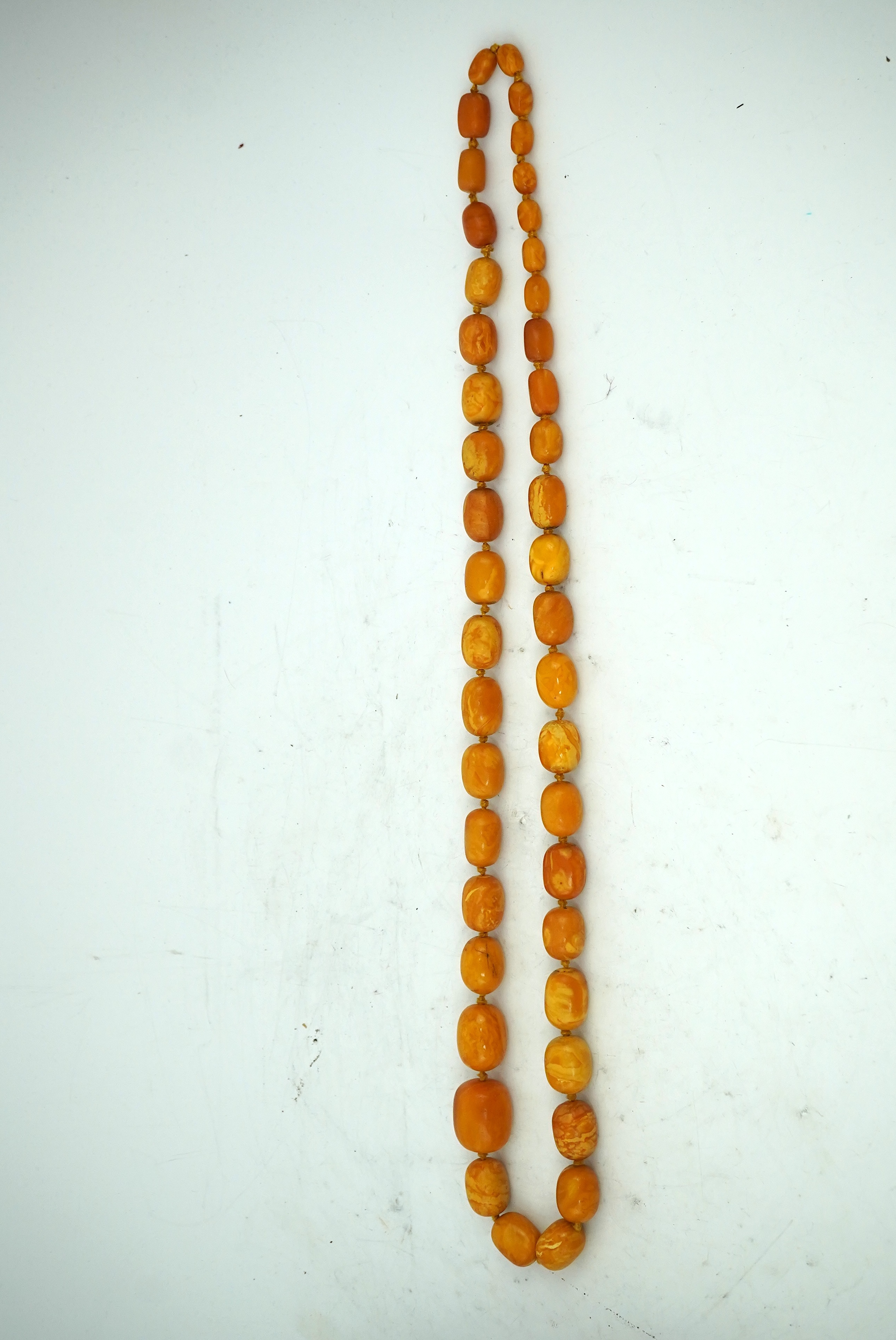 A single strand graduated oval amber bead necklace